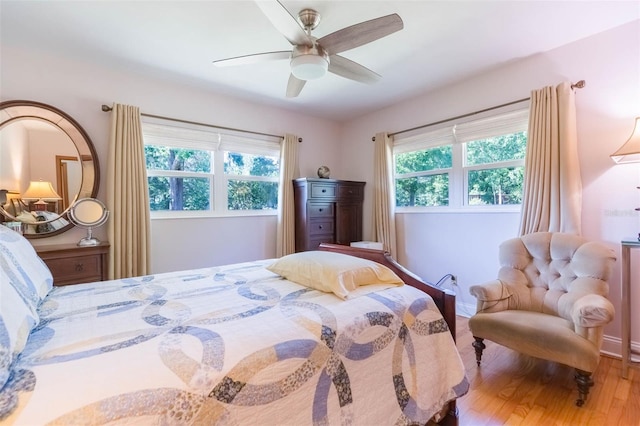 bedroom featuring baseboards, ceiling fan, and wood finished floors