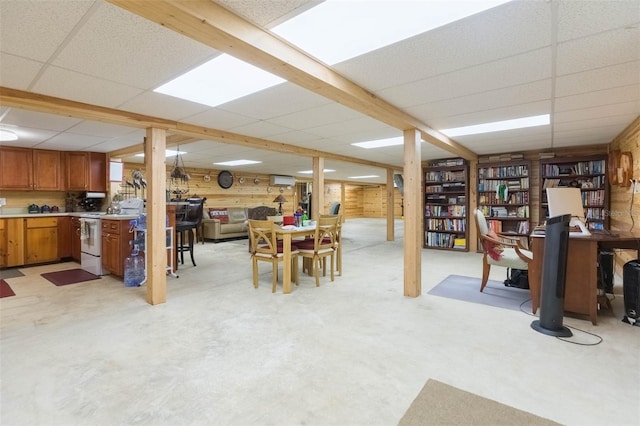 finished basement with wood walls and a drop ceiling