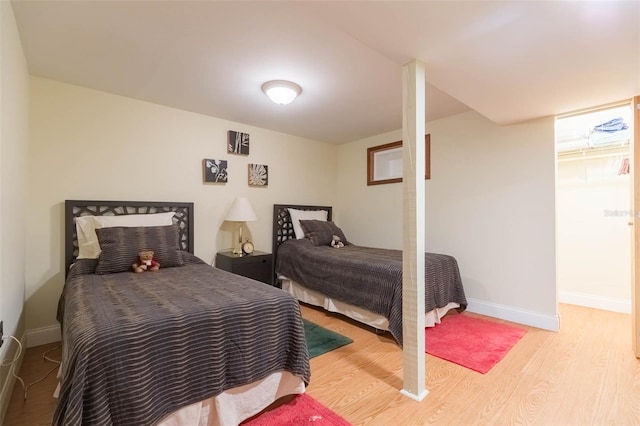 bedroom with baseboards and light wood-type flooring