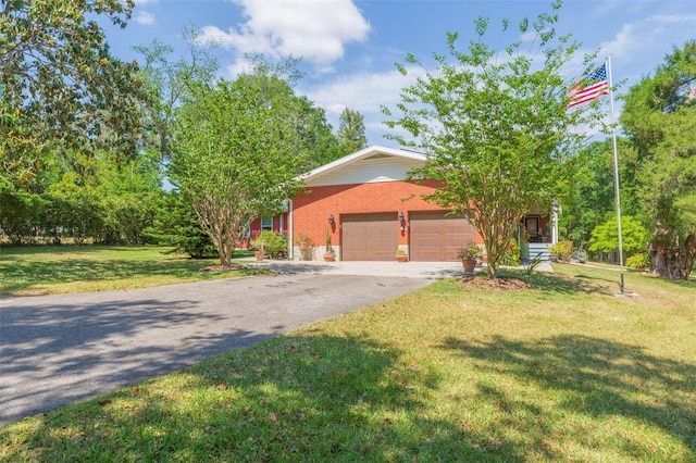 view of front of property with an attached garage, brick siding, driveway, and a front yard