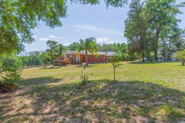 view of yard featuring fence and a wooden deck