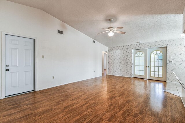 unfurnished living room with visible vents, a ceiling fan, a textured ceiling, and lofted ceiling