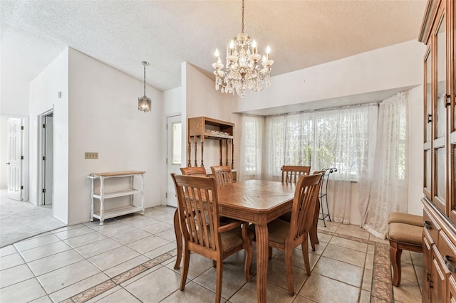 dining space featuring light tile patterned floors, a textured ceiling, lofted ceiling, and a chandelier