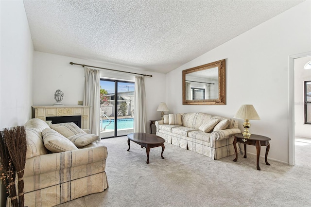living area featuring lofted ceiling, a textured ceiling, and carpet
