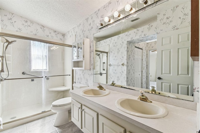 full bath with a shower stall, wallpapered walls, and a sink