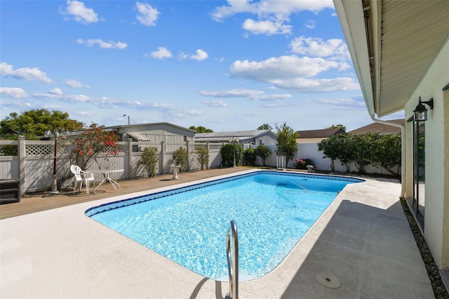view of swimming pool featuring a fenced in pool, a fenced backyard, and a patio area