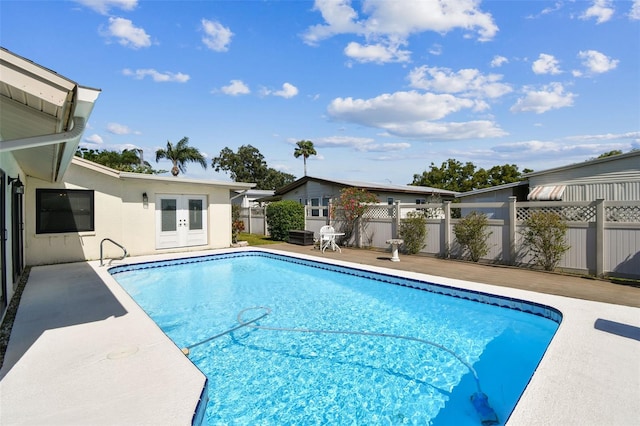 view of pool featuring a patio, a fenced in pool, french doors, and fence
