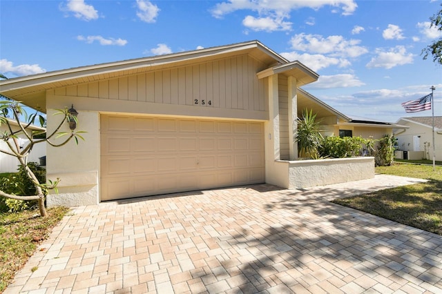 garage featuring decorative driveway