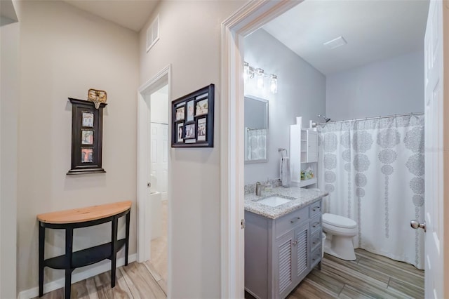 4516 Savannah Holly Pl, Riverview, FL 33578 - bathroom with a shower with curtain, toilet, visible vents, wood finished floors, and vanity