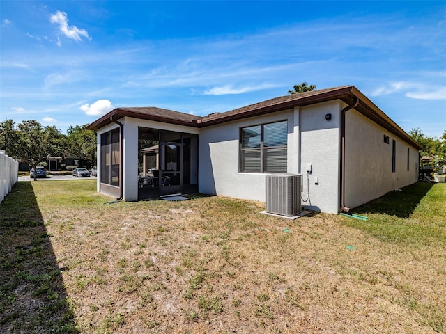 4516 Savannah Holly Pl, Riverview, FL 33578 - back of property with a lawn, a sunroom, cooling unit, and stucco siding