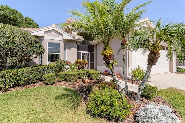 view of front of house with stucco siding, concrete driveway, and a garage