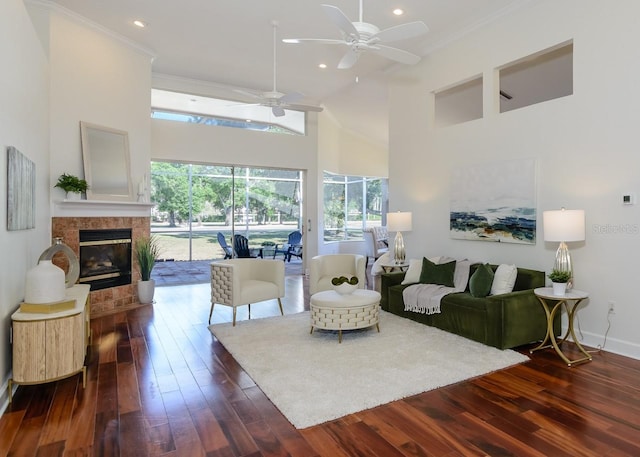 living area featuring recessed lighting, ceiling fan, a high ceiling, and dark wood-type flooring