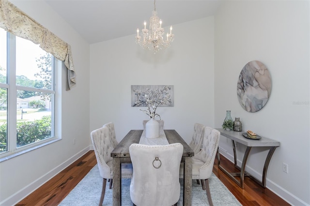 dining area featuring a chandelier, wood finished floors, and a healthy amount of sunlight