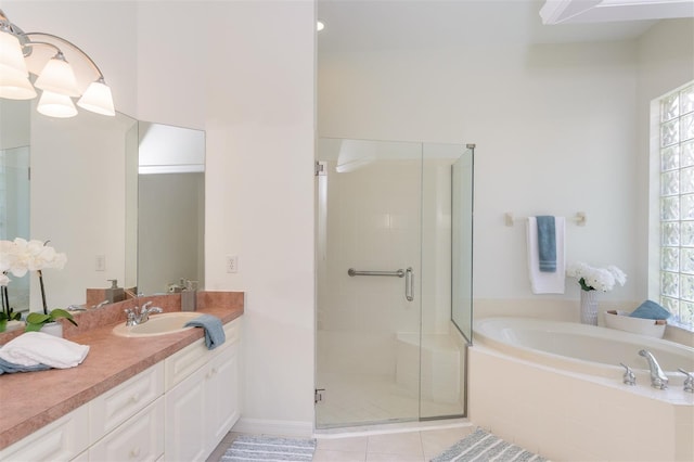 full bathroom with tile patterned floors, a wealth of natural light, a garden tub, and a stall shower