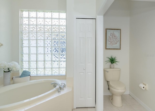 bathroom with toilet, a bath, tile patterned flooring, and a closet