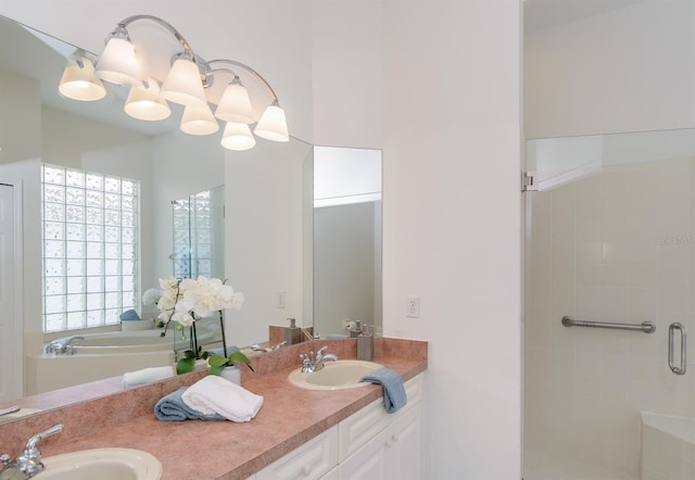 bathroom with double vanity, a sink, and a shower stall