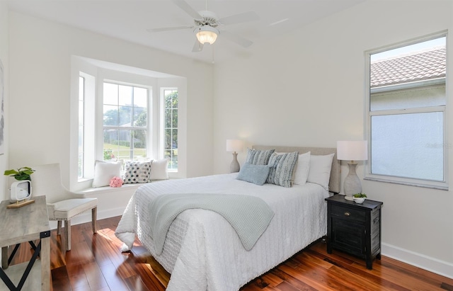 bedroom featuring ceiling fan, dark wood finished floors, and baseboards