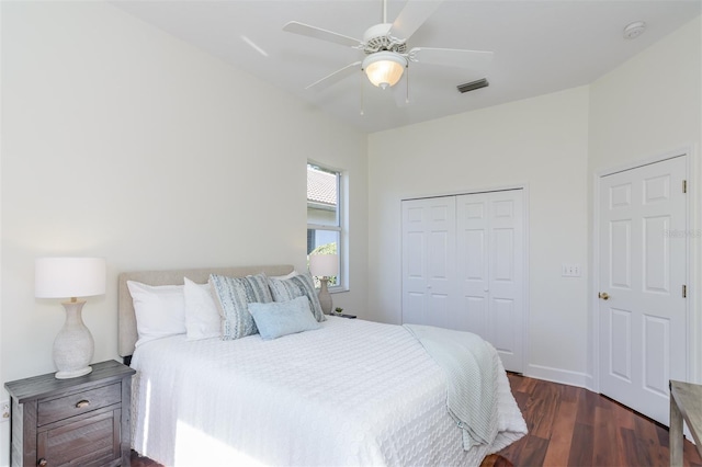 bedroom featuring a closet, visible vents, a ceiling fan, and dark wood finished floors