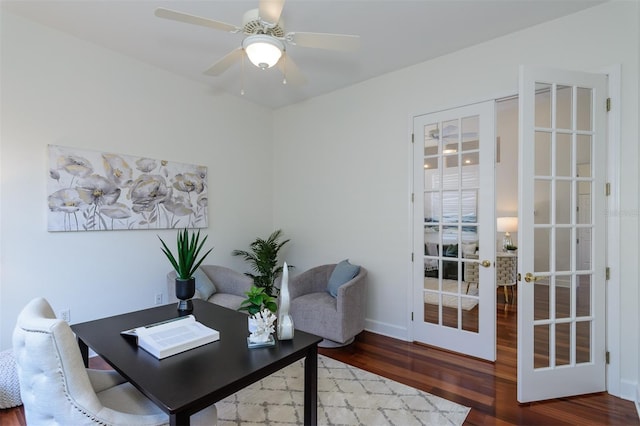 office space featuring baseboards, wood finished floors, a ceiling fan, and french doors