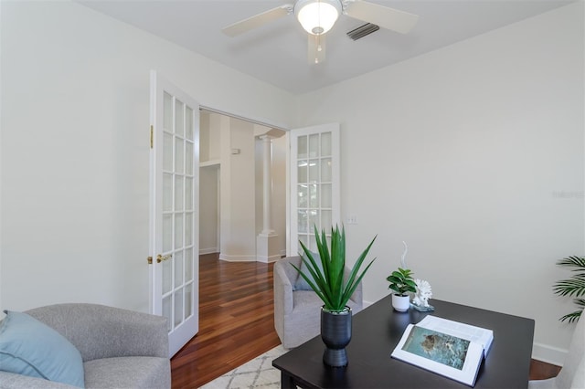 office space with a ceiling fan, visible vents, wood finished floors, and french doors