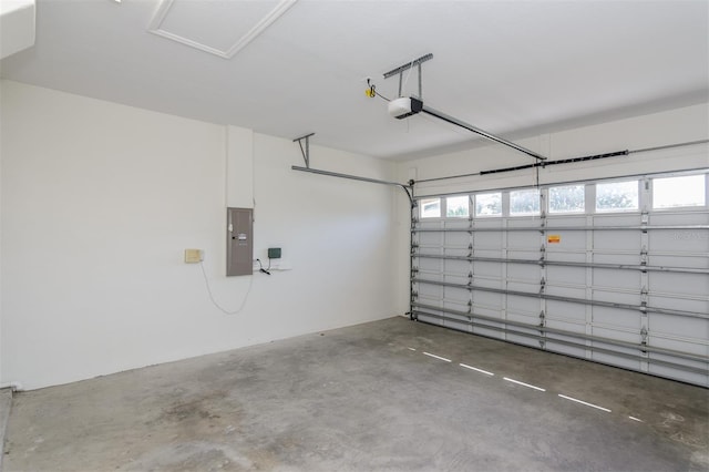 garage featuring electric panel and a garage door opener