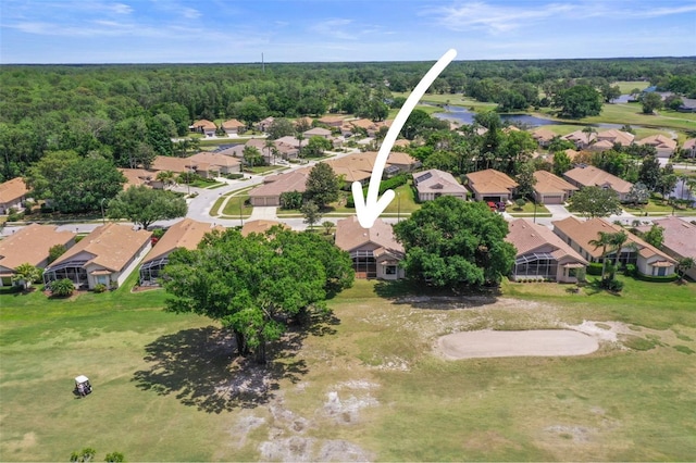 drone / aerial view with a residential view, a water view, and a forest view