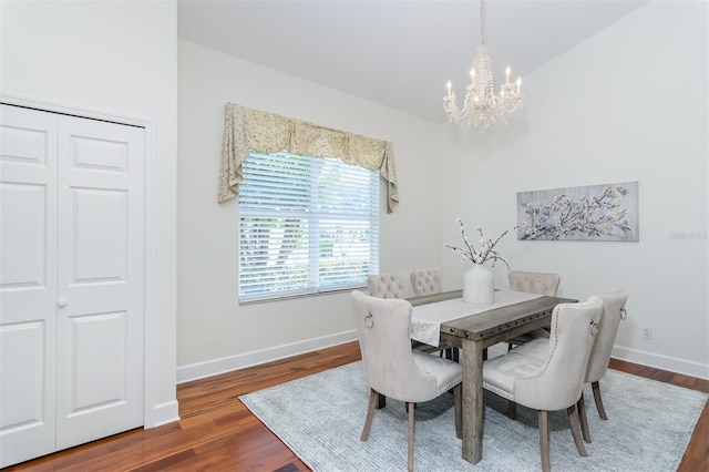3964 Silk Oak Ln, Palm Harbor, FL 34685 - dining area featuring a chandelier, dark wood-type flooring, and baseboards