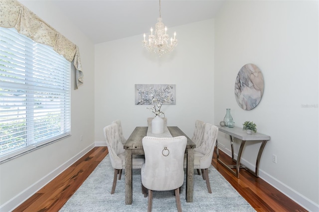 3964 Silk Oak Ln, Palm Harbor, FL 34685 - dining room with a chandelier, wood finished floors, and baseboards