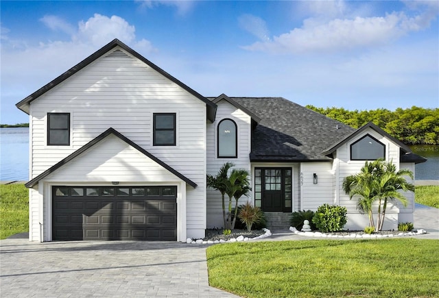 6627 Dolphin Cove Dr, Apollo Beach, FL 33572 - view of front of property with a garage, driveway, a front lawn, and roof with shingles