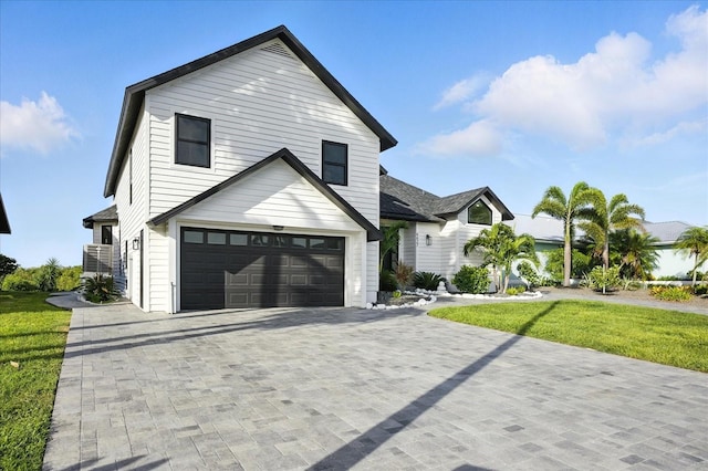 6627 Dolphin Cove Dr, Apollo Beach, FL 33572 - view of front of house with an attached garage, decorative driveway, and a front lawn