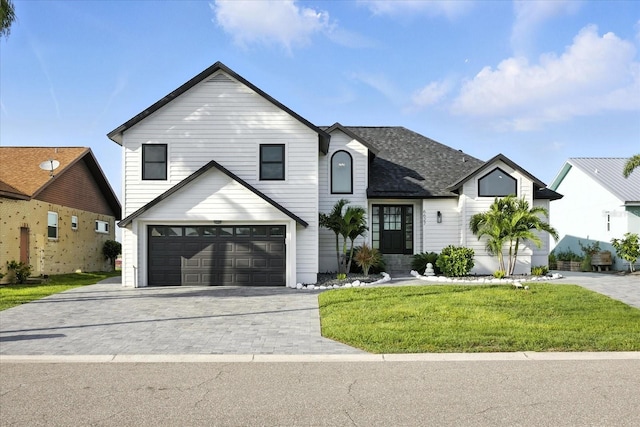 6627 Dolphin Cove Dr, Apollo Beach, FL 33572 - view of front facade with a garage, a front yard, driveway, and roof with shingles