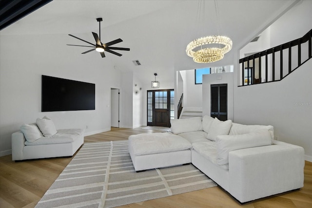 6627 Dolphin Cove Dr, Apollo Beach, FL 33572 - living room with stairs, high vaulted ceiling, a chandelier, a ceiling fan, and wood finished floors