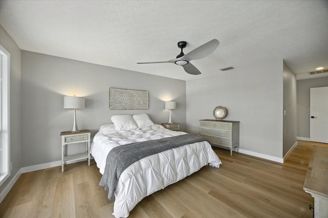 6627 Dolphin Cove Dr, Apollo Beach, FL 33572 - bedroom featuring wood finished floors, ceiling fan, and a textured ceiling