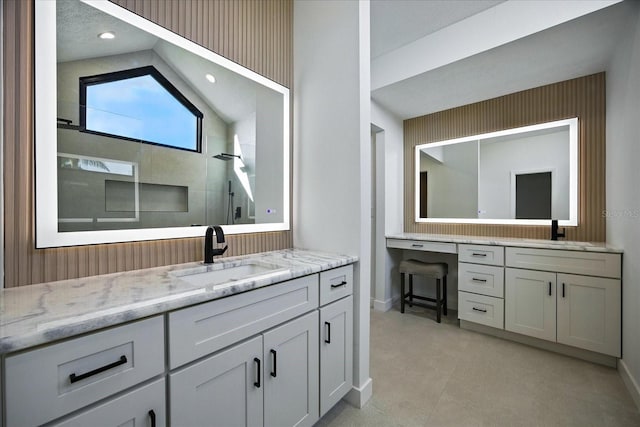 6627 Dolphin Cove Dr, Apollo Beach, FL 33572 - bathroom with two vanities, tiled shower, and lofted ceiling