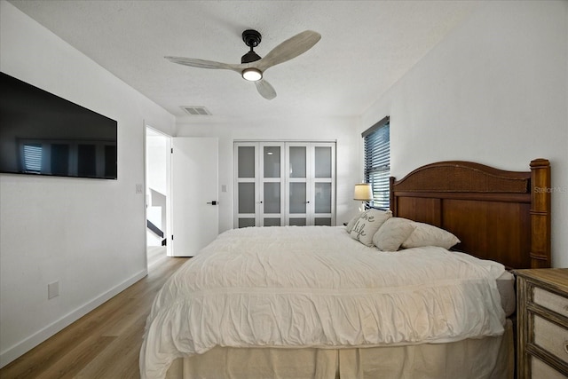 6627 Dolphin Cove Dr, Apollo Beach, FL 33572 - bedroom featuring wood finished floors, a ceiling fan, and a textured ceiling