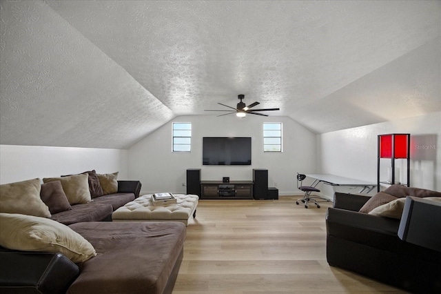 6627 Dolphin Cove Dr, Apollo Beach, FL 33572 - living room featuring a textured ceiling, lofted ceiling, ceiling fan, and light wood-type flooring