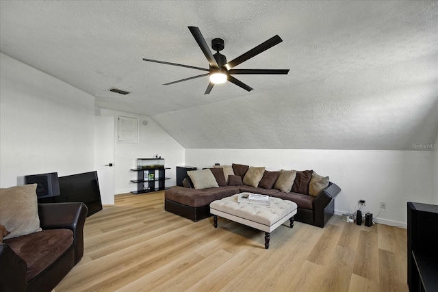 6627 Dolphin Cove Dr, Apollo Beach, FL 33572 - living area featuring a textured ceiling, ceiling fan, light wood-style floors, and lofted ceiling