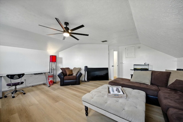 6627 Dolphin Cove Dr, Apollo Beach, FL 33572 - living room with a textured ceiling, vaulted ceiling, wood finished floors, and a ceiling fan