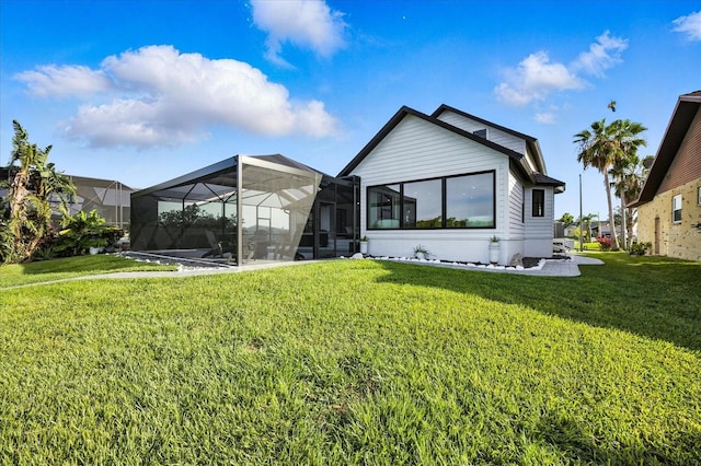 6627 Dolphin Cove Dr, Apollo Beach, FL 33572 - rear view of house featuring a yard and glass enclosure