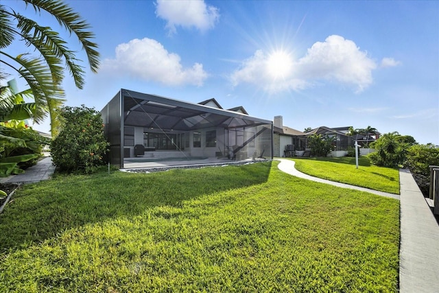 6627 Dolphin Cove Dr, Apollo Beach, FL 33572 - rear view of property with a yard and glass enclosure