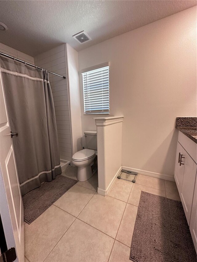 6942 Ripple Pond Loop, Zephyrhills, FL 33541 - full bath featuring vanity, toilet, a textured ceiling, tile patterned floors, and visible vents
