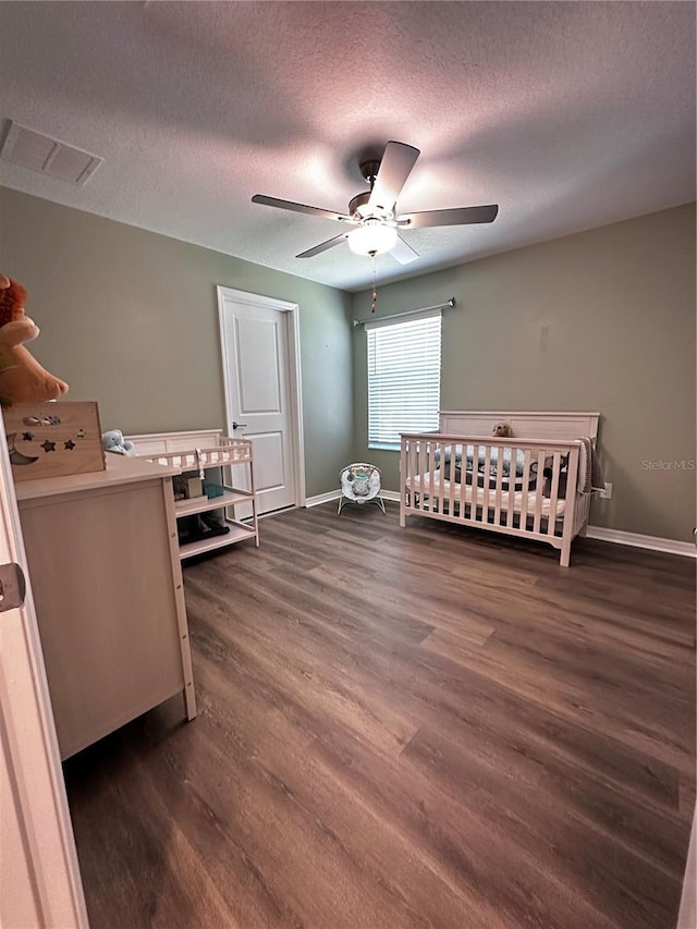 6942 Ripple Pond Loop, Zephyrhills, FL 33541 - bedroom with a ceiling fan, a textured ceiling, visible vents, baseboards, and dark wood-style floors