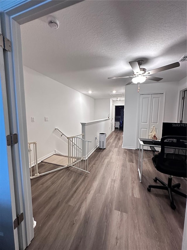6942 Ripple Pond Loop, Zephyrhills, FL 33541 - office area with baseboards, a textured ceiling, ceiling fan, and wood finished floors