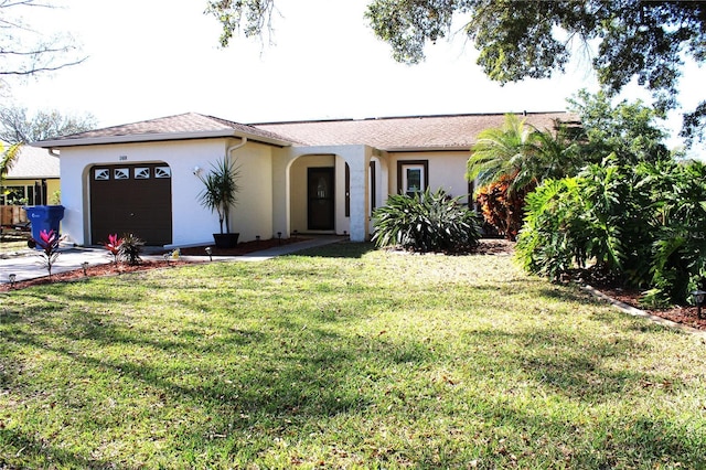 2460 Beacon Groves Blvd, Palm Harbor, FL 34683 - ranch-style house featuring an attached garage, driveway, a front lawn, and stucco siding
