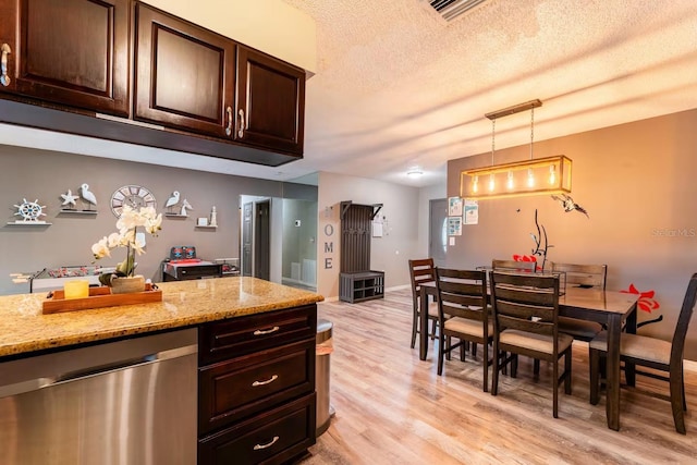 2460 Beacon Groves Blvd, Palm Harbor, FL 34683 - kitchen with dark brown cabinetry, light stone countertops, light wood finished floors, dishwasher, and hanging light fixtures