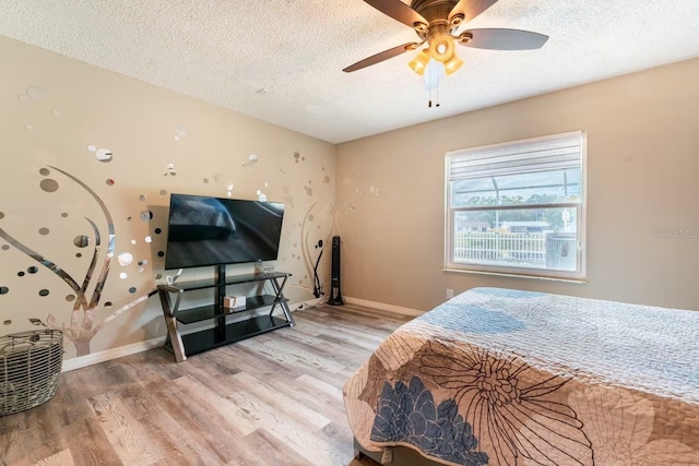 2460 Beacon Groves Blvd, Palm Harbor, FL 34683 - bedroom with baseboards, a textured ceiling, and wood finished floors