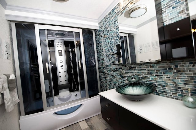 2460 Beacon Groves Blvd, Palm Harbor, FL 34683 - bathroom featuring tasteful backsplash, wood finished floors, vanity, ornamental molding, and tub / shower combination