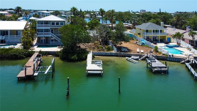 view of dock with boat lift, a residential view, and a water view