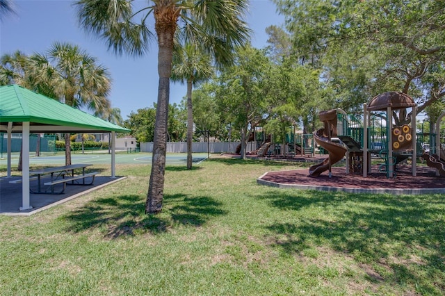 view of yard featuring fence, playground community, and a gazebo