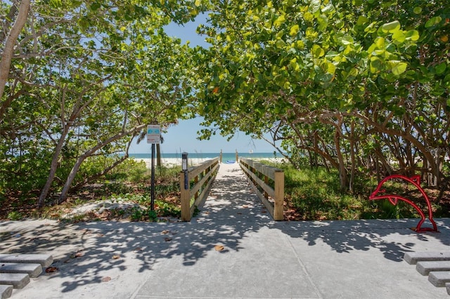 view of community featuring a beach view and a water view